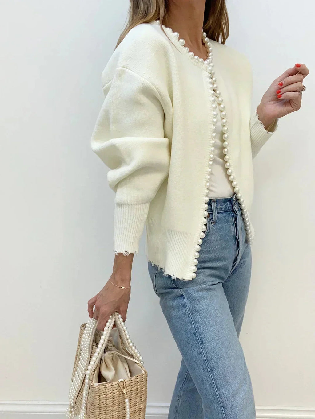 Women's open front cardigan featuring pearl trim, crafted from soft knit fabric for comfort and style in casual wear.