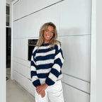 Cozy women's striped sweater made from soft cotton blend, featuring a relaxed fit and long sleeves for everyday comfort.