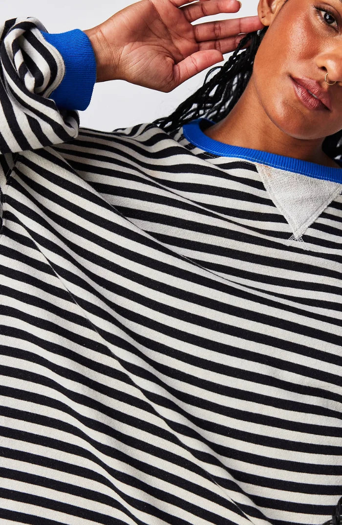 Women's striped sweater in a relaxed fit, crafted from soft cotton, featuring long sleeves and a comfortable crew neckline.
