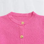 Women's knitted button-up cardigan, featuring a cozy fabric with a classic design and textured buttons for added style.