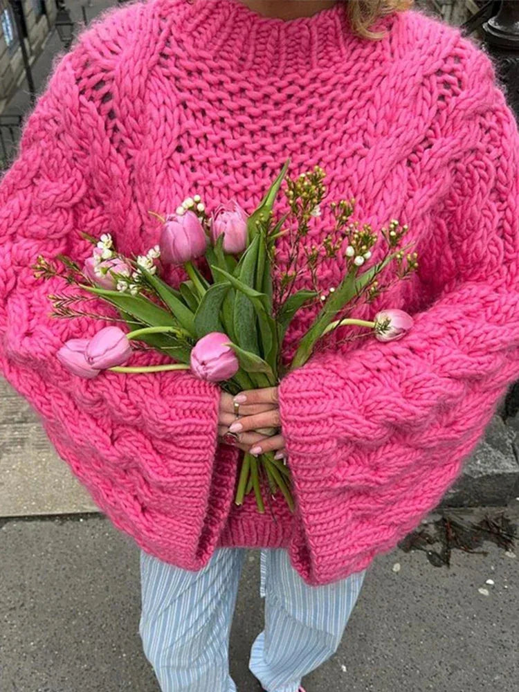 Women's chunky knit oversized sweater with wide sleeves, featuring a cozy texture and relaxed fit for comfortable layering.
