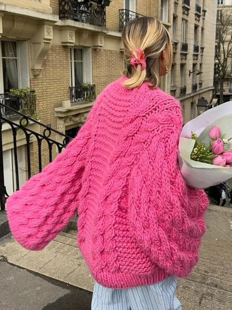 Women’s oversized chunky knit sweater with wide sleeves, featuring soft yarn for warmth and a relaxed, cozy fit.
