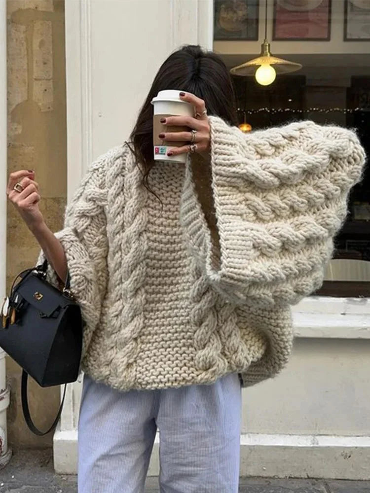 Women's chunky knit oversized sweater in soft yarn, featuring wide sleeves and a relaxed fit for comfort and style.