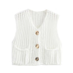 Women's chunky knit vest with pockets, made of soft, warm yarn featuring a relaxed fit and textured knit pattern.