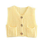 Women's chunky knit vest with pockets, crafted from soft acrylic yarn, featuring a relaxed fit and textured pattern.