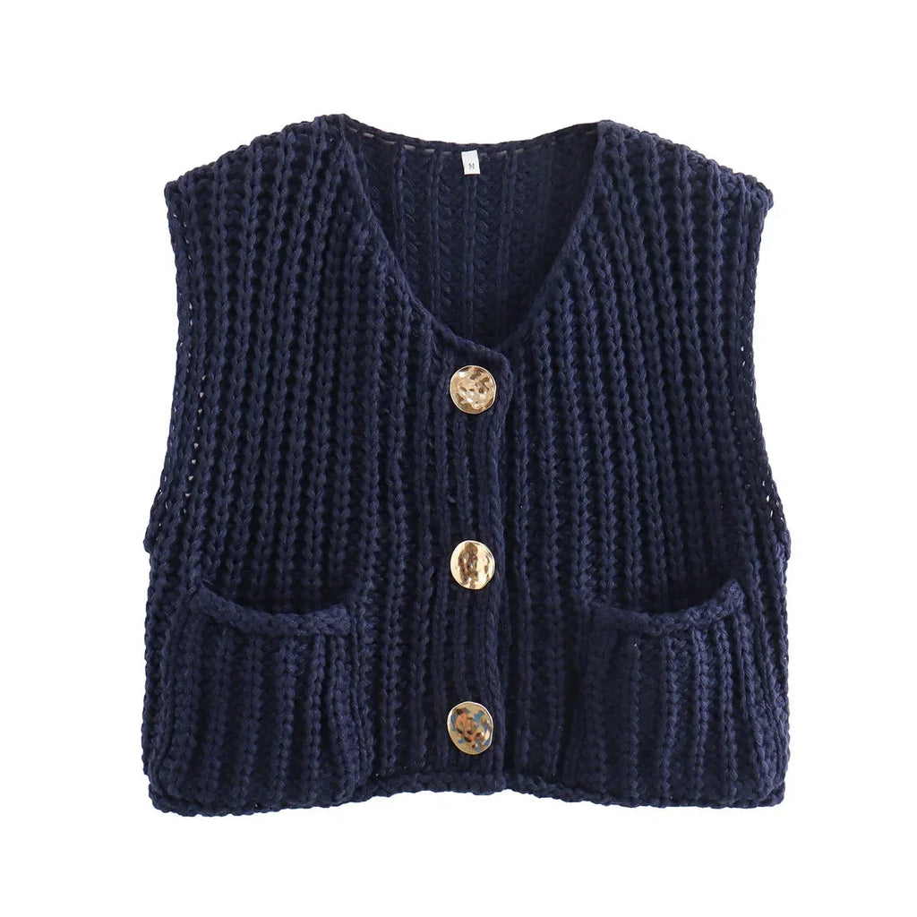 Women's chunky knit vest with pockets, made of soft acrylic yarn, featuring a relaxed fit and ribbed edges for a cozy look.