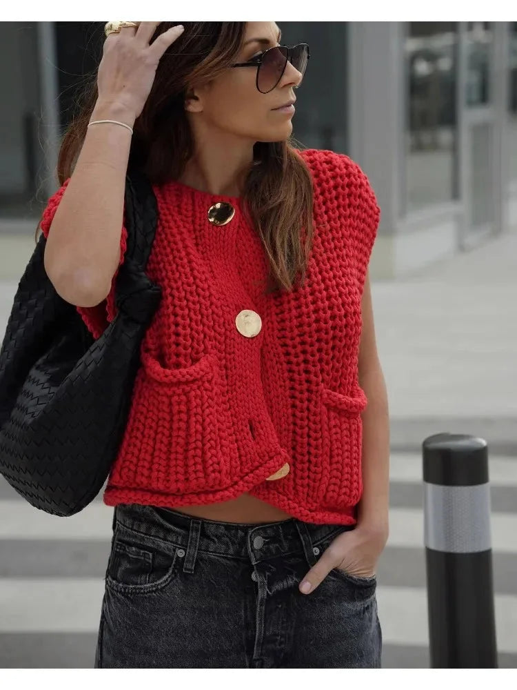 Women's chunky knit vest with pockets, crafted from soft yarn, featuring a cozy, oversized design perfect for layering.