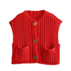 Cozy women's chunky knit vest with pockets, made from soft yarn, featuring a relaxed fit and textured pattern for warmth.