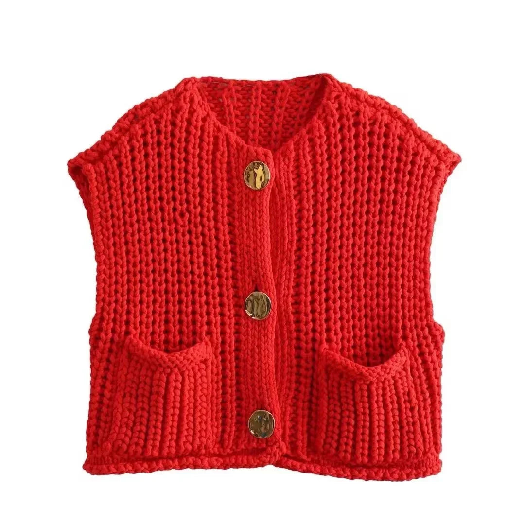 Cozy women's chunky knit vest with pockets, made from soft yarn, featuring a relaxed fit and textured pattern for warmth.