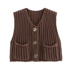 Women's chunky knit vest with pockets, made from soft, warm fabric with a textured design and practical side pockets.