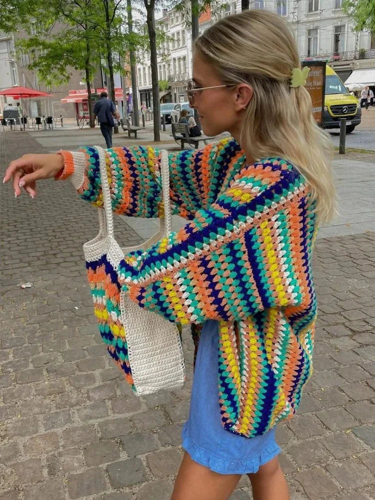 Women's colorful knitted cardigan featuring rainbow stripes, made from soft acrylic blend, showcasing an open front design.