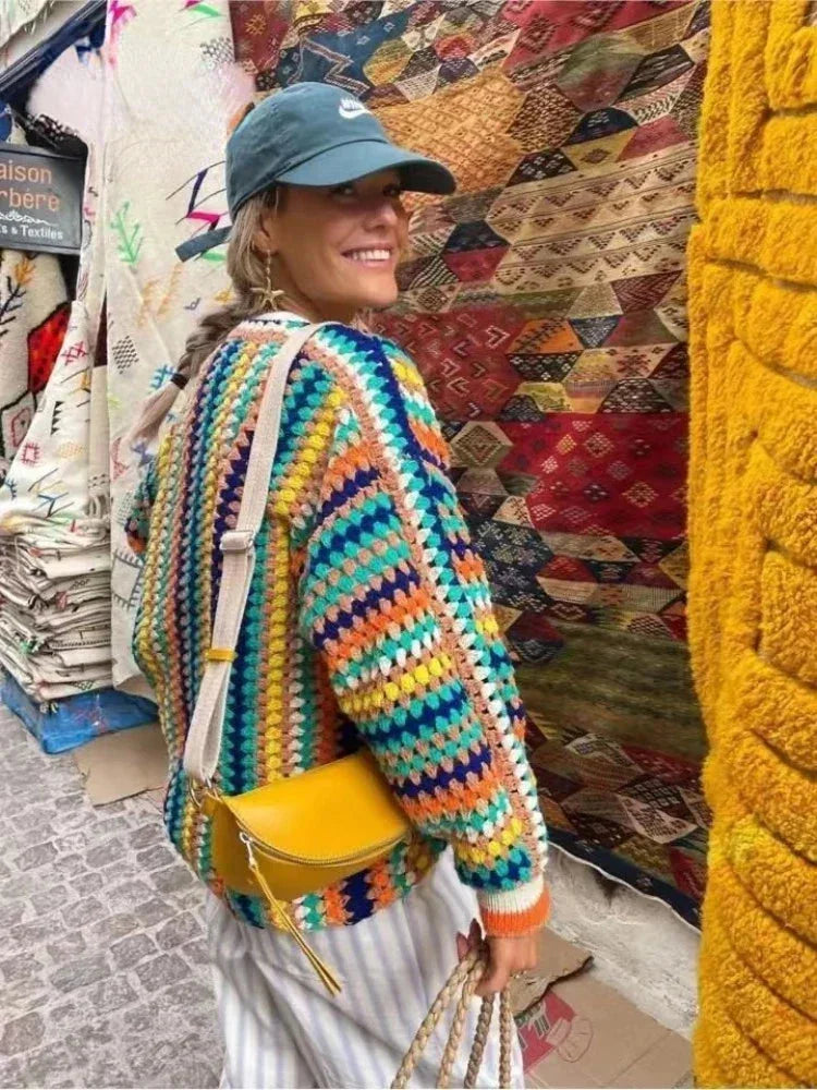 Women's colorful knitted cardigan featuring rainbow stripes, crafted from soft yarn for comfort and warmth during chilly…