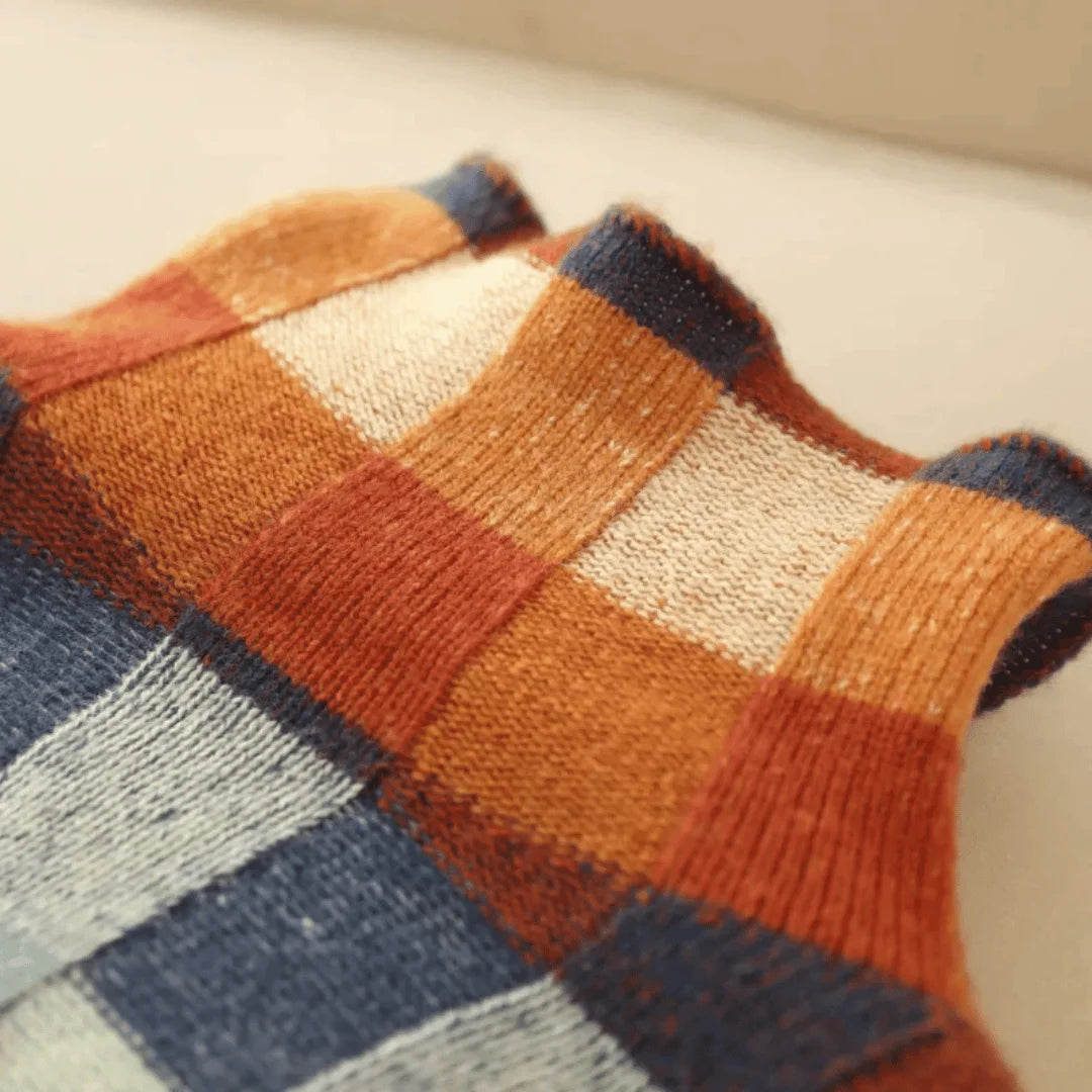 Women's vibrant patchwork turtleneck sweater made from soft knit fabric, featuring a cozy, relaxed fit for everyday wear.