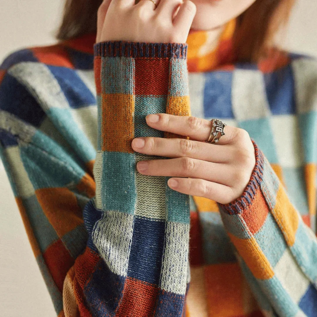 Colorful patchwork turtleneck sweater for women made of soft knit fabric, featuring a cozy fit and unique patterns.