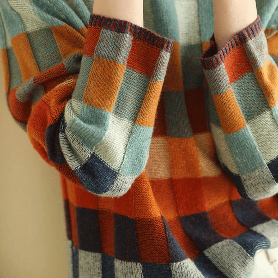 Women's turtleneck sweater featuring a colorful patchwork design made from soft yarn for a cozy fit.