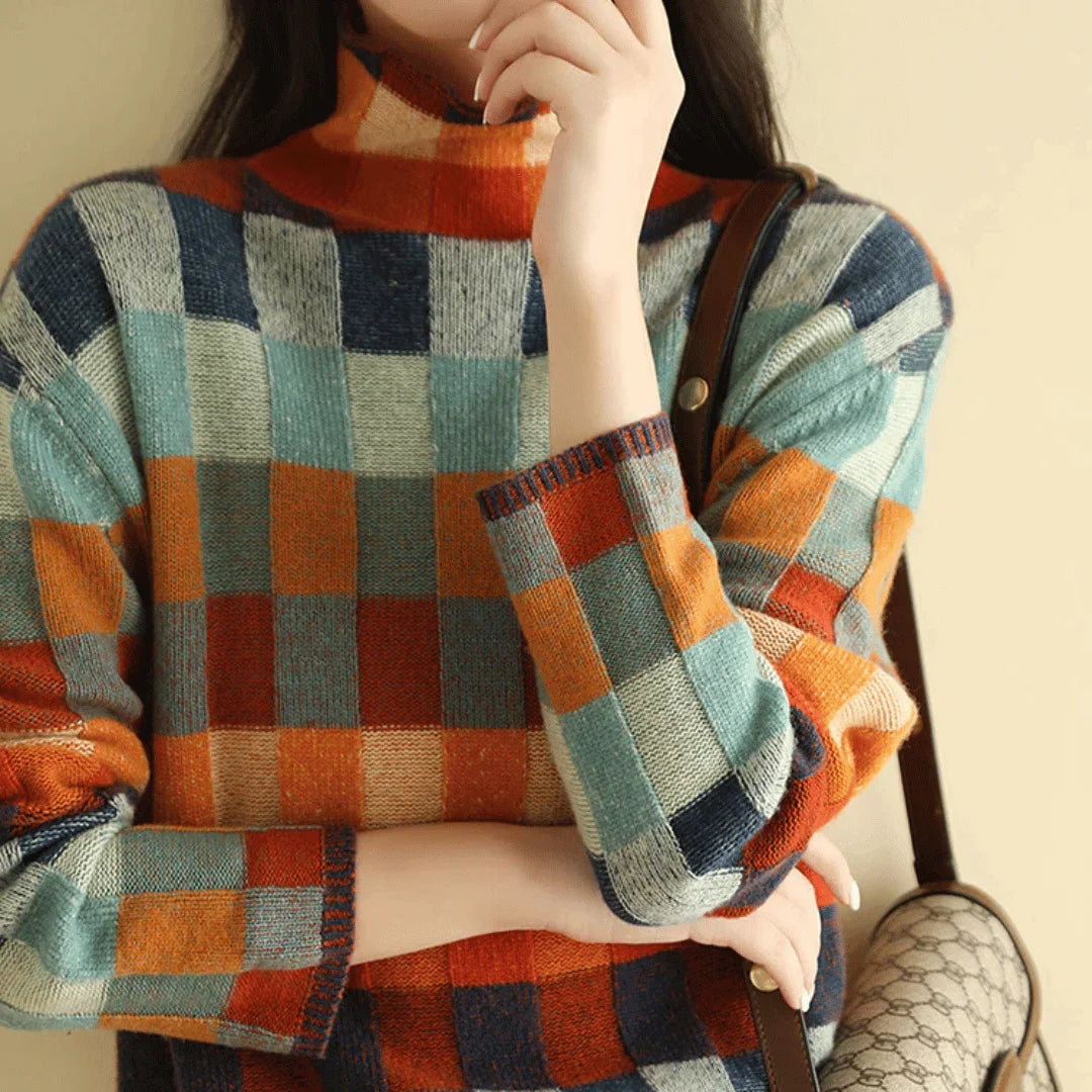 Women's colorful patchwork turtleneck sweater made from soft knit fabric featuring a unique multi-patterned design.