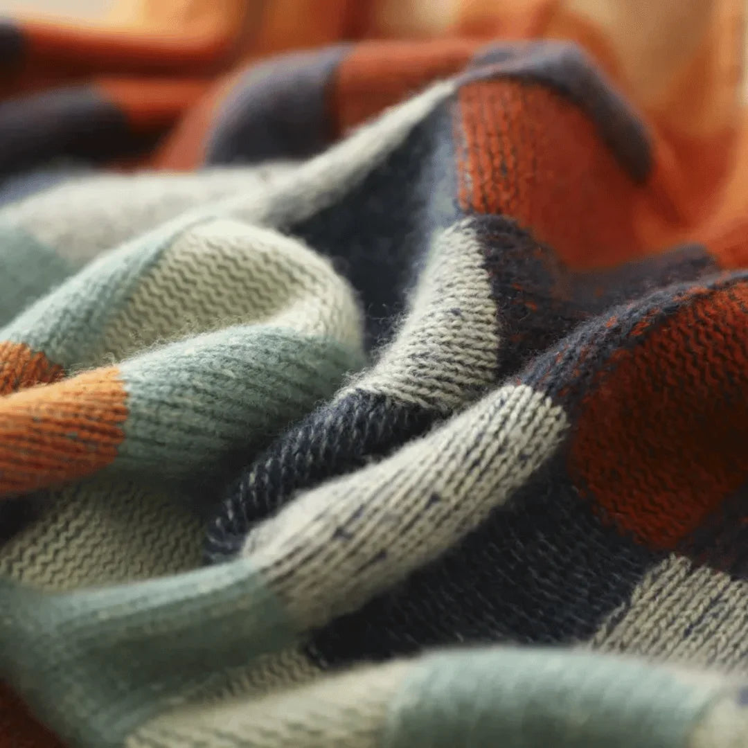Alt text: Women's turtleneck sweater featuring colorful patchwork design, made from soft knit fabric for warmth and comfort.