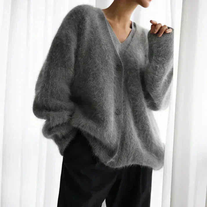 Women's cozy button-up cardigan with long sleeves, crafted from soft knit fabric, featuring a relaxed fit and classic button…