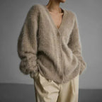 Women's cozy button-up cardigan with long sleeves, made of soft knit fabric, featuring a relaxed fit and functional buttons.