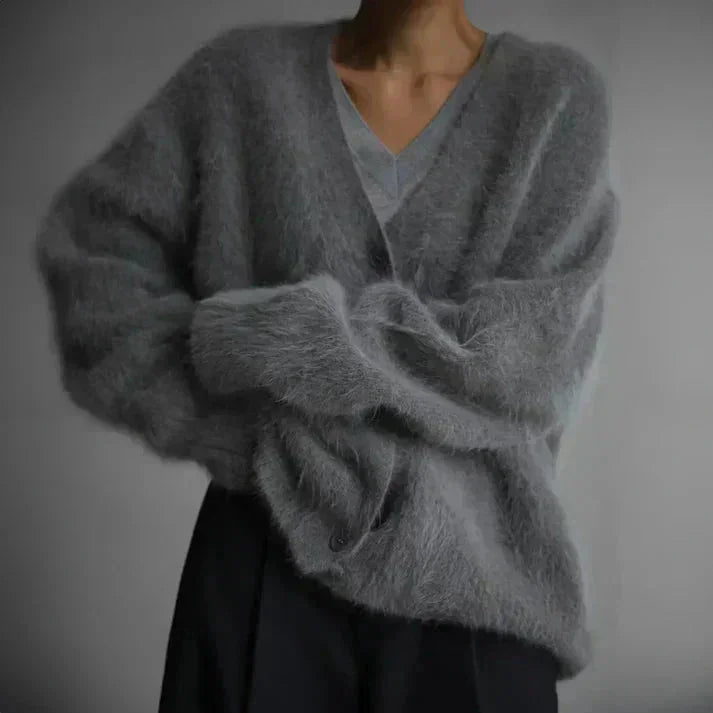 Warm women's button-up cardigan featuring long sleeves and soft knit fabric for comfort and style in casual wear.