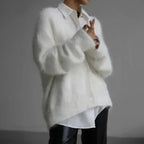 Women's button-up cardigan with long sleeves, made from soft knit fabric, featuring a relaxed fit and classic ribbed…