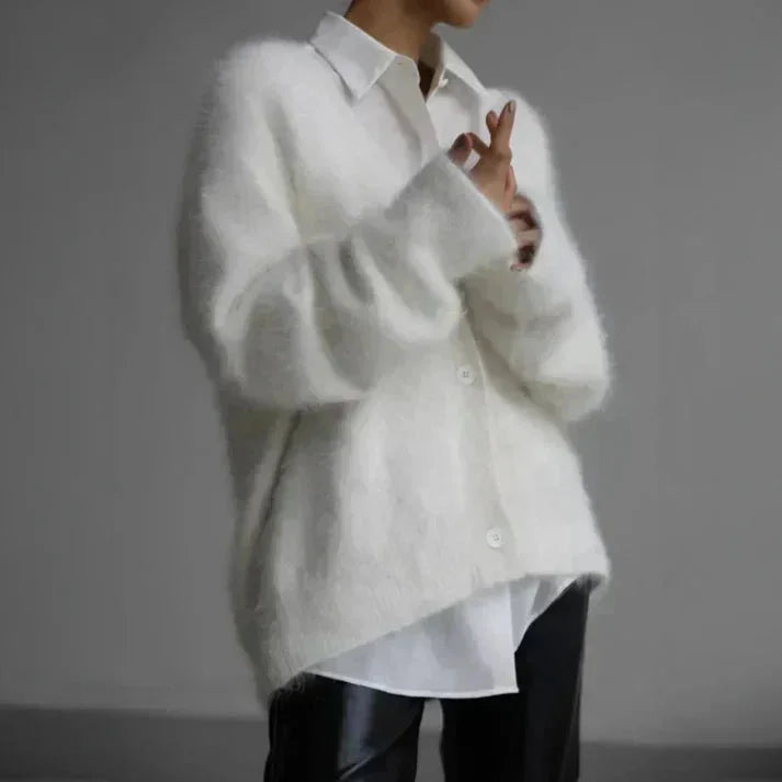 Women's button-up cardigan with long sleeves, made from soft knit fabric, featuring a relaxed fit and classic ribbed…