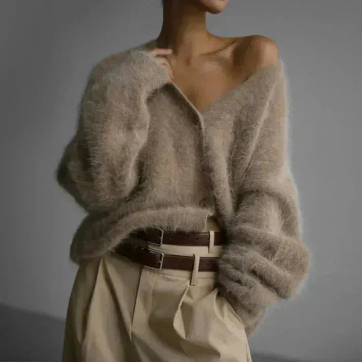 Women's button-up cardigan made of soft knit fabric, featuring long sleeves and a relaxed fit for comfort and warmth.