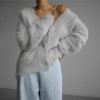 Women's cozy button-up cardigan featuring long sleeves and soft knit fabric, ideal for layering in cool weather.