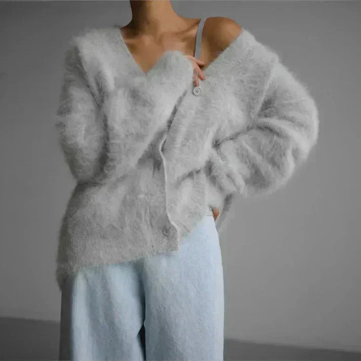 Women's cozy button-up cardigan featuring long sleeves and soft knit fabric, ideal for layering in cool weather.