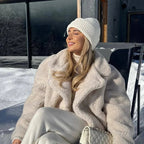 "Women's cream faux fur jacket with lapels, featuring a soft texture and a warm design suitable for chilly weather."