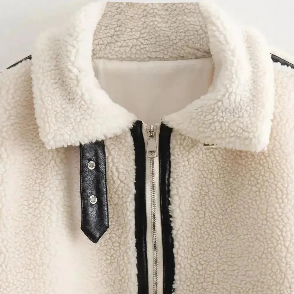 Women’s cozy cream teddy jacket with zip-up front, featuring side pockets and soft fabric for warmth and comfort.