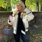 Cozy cream zip-up teddy jacket for women, featuring soft fabric, front pockets, and a contemporary design for everyday wear.