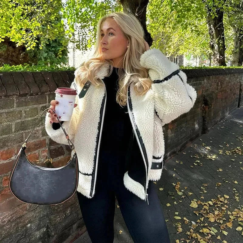 Cozy cream zip-up teddy jacket for women, featuring soft fabric, front pockets, and a contemporary design for everyday wear.