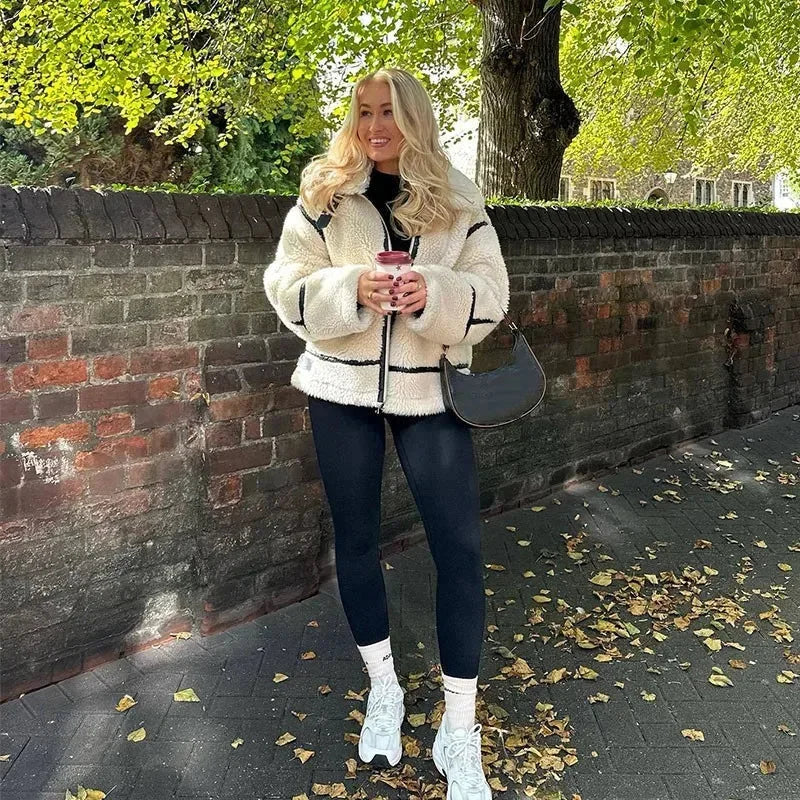 Women's cream teddy jacket with zip-up front, pockets, and soft, cozy fabric for warmth and comfort. Perfect for casual wear.