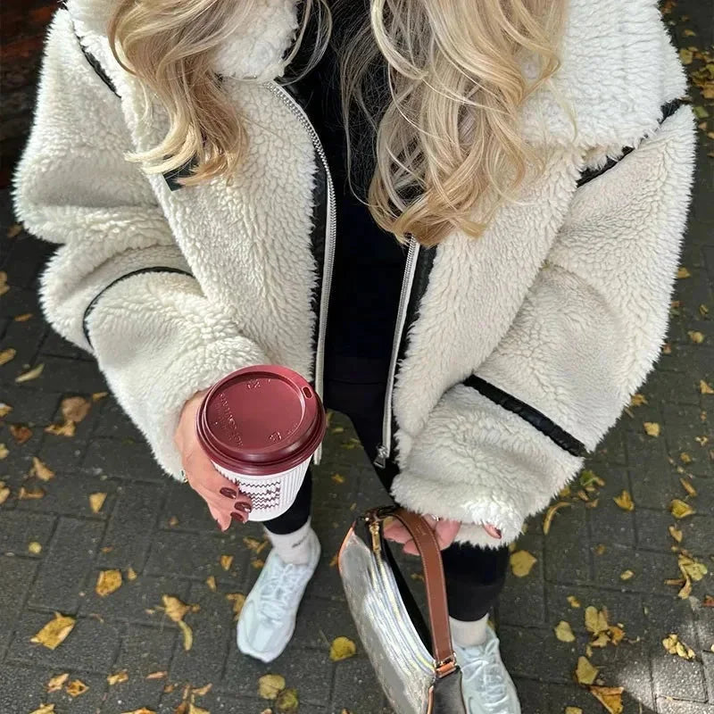Cozy cream zip-up teddy jacket for women, featuring soft fabric, two pockets, and a relaxed fit for comfort.