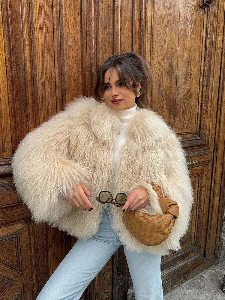 Women's cozy fluffy faux fur jacket in a soft, textured material with a relaxed fit and front pockets for added comfort.