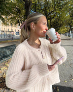 Women's cozy knit cardigan featuring a button front, soft fabric, and a relaxed fit for comfortable layering.
