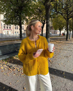 Women's cozy knit cardigan with button front, designed for warmth and comfort, featuring a soft texture and relaxed fit.