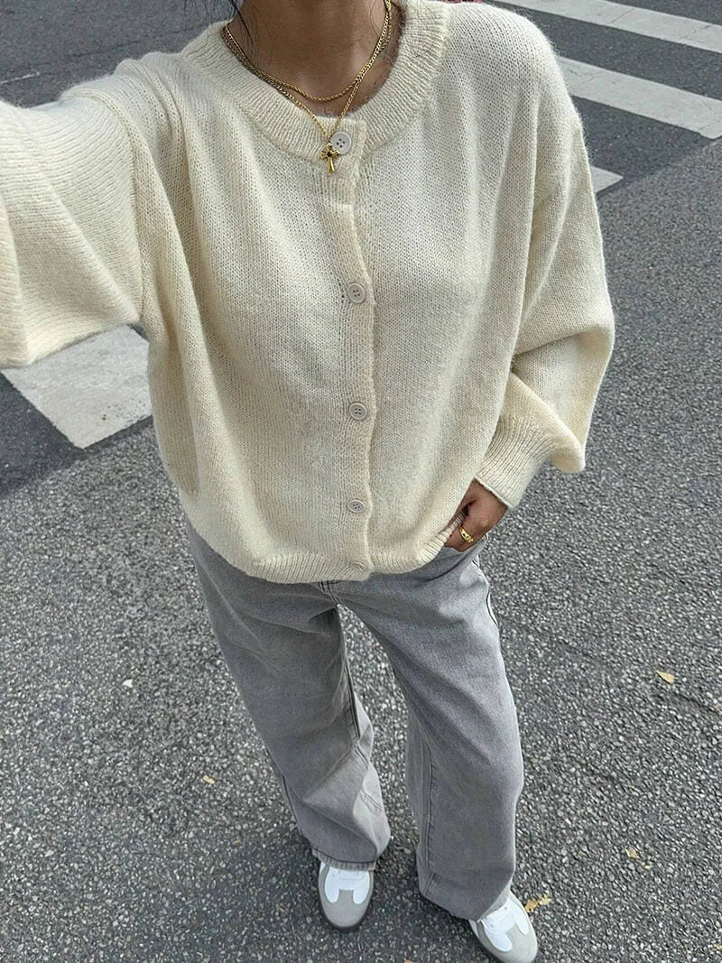 Women's knitted cardigan featuring a button front, crafted from soft yarn for comfort and warmth in a relaxed fit.