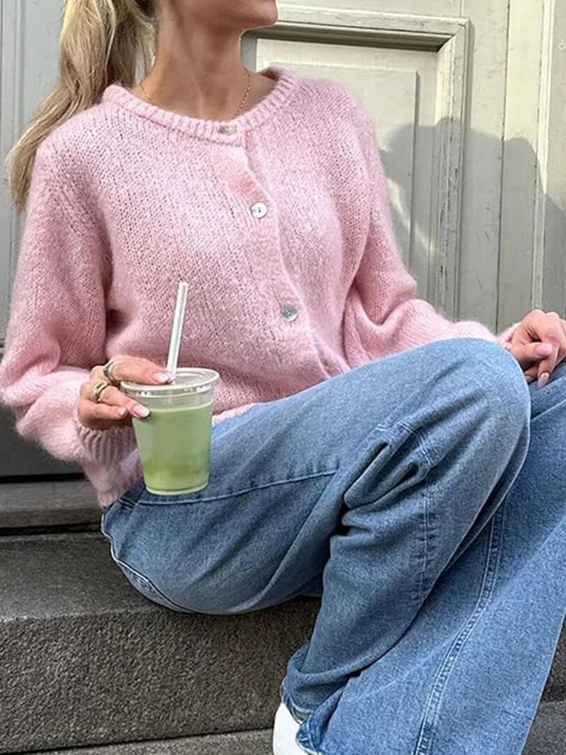 Women’s cozy knitted cardigan with button front, featuring soft yarn, ribbed cuffs, and a relaxed fit for comfortable…