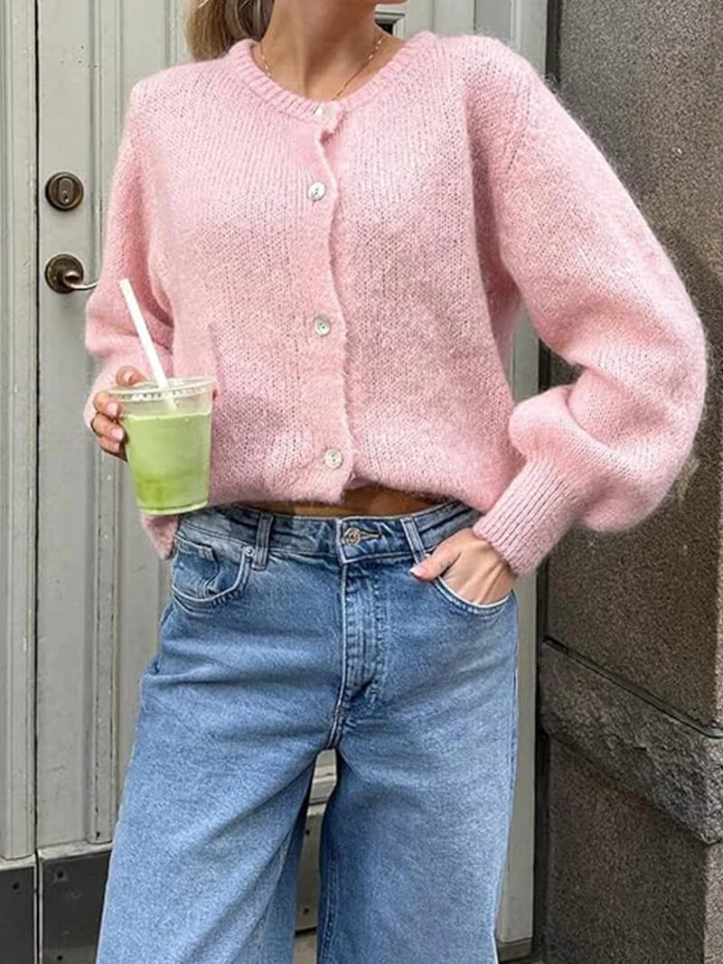 Women's cozy knitted cardigan with button front, featuring soft yarn, ribbed cuffs, and a relaxed fit for everyday comfort.