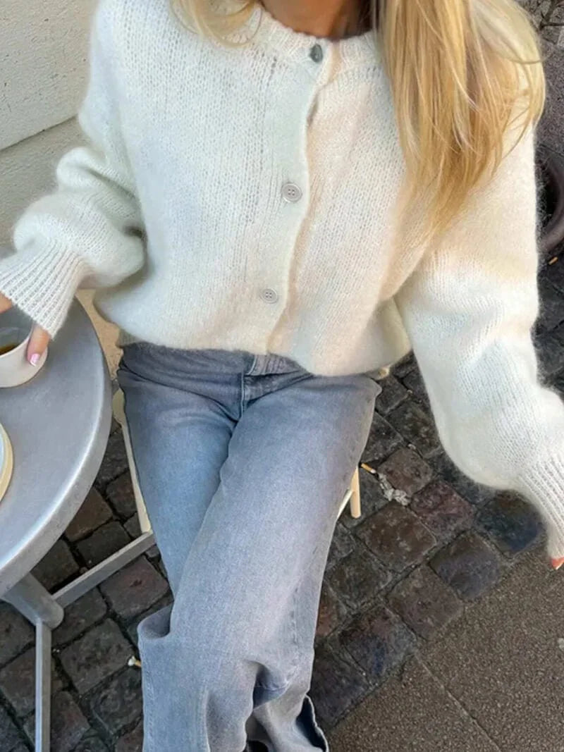 Women's cozy knitted cardigan featuring a button front, crafted from soft yarn for warmth and comfort in everyday wear.