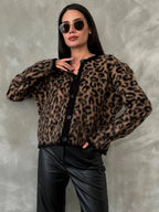 Women's cozy knitted cardigan featuring a button front, made from soft yarn, with a relaxed fit and ribbed cuffs.