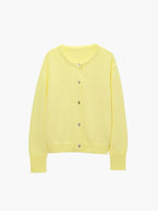 Women's cozy knitted cardigan featuring a button front, soft yarn, and ribbed cuffs for warmth and comfort.