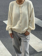 Women's knitted cardigan with button front, made from soft, warm fabric, featuring a relaxed fit and classic ribbed…