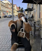 Women's oversized teddy coat in soft fabric, featuring a wide collar and relaxed fit for comfort and style during colder…