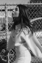 Women's cream cardigan made of soft knit fabric featuring large statement buttons and a relaxed fit for casual wear.