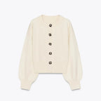 Women's cream cardigan with statement buttons, featuring a soft knit material and a relaxed fit for everyday comfort.
