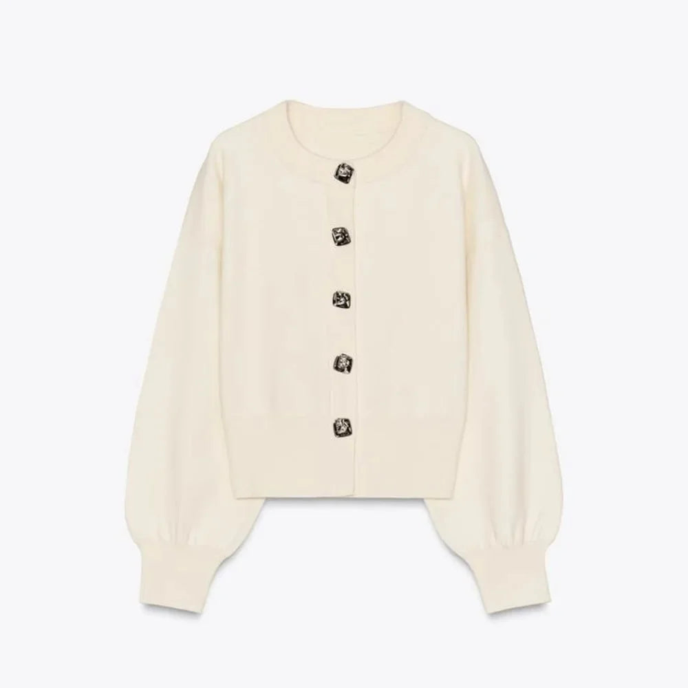 Women's cream cardigan with statement buttons, featuring a soft knit material and a relaxed fit for everyday comfort.