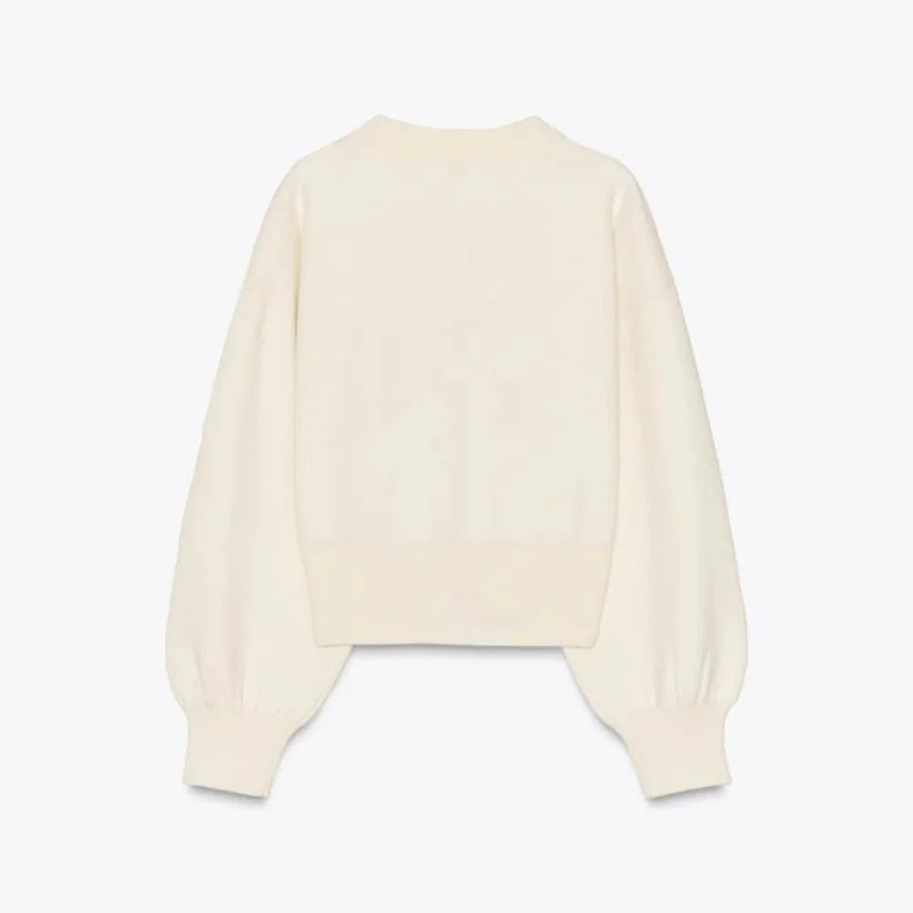 Women's cream cardigan with large statement buttons, crafted from soft knit material with a relaxed fit for everyday comfort.